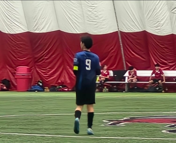 A young MindsetFC player walking onto the field